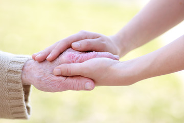 Senior and Young Women Holding Hands