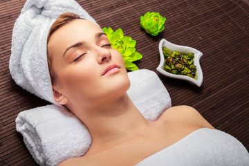 Young beauty woman in a spa with closed eyes