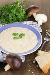Mashed potatoes in plate with ingredients on table close-up