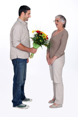 Son giving mother flowers