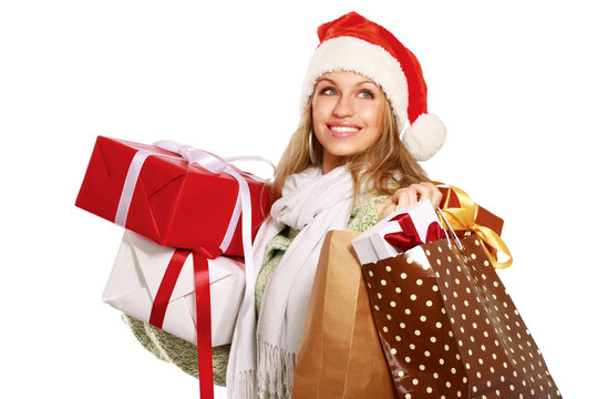 young woman with Santa hat holding shopping bags