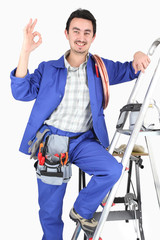 Man with ladder and plumbing tools