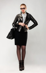 Fototapeta premium Fashionable confident trendy woman in sunglasses and handbag