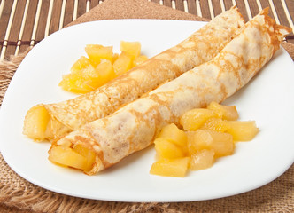 Sweet crepes with apple caramel and cream 