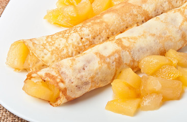 Sweet crepes with apple caramel and cream 