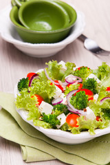 salad with tomatoes, broccoli, red onion and feta cheese