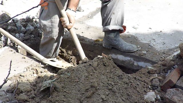Construction worker digging ground
