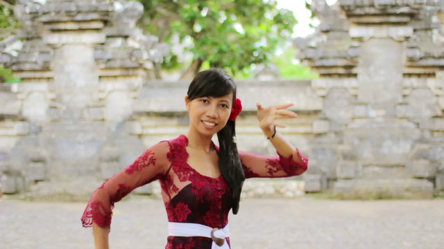 Balinese Girl Dancing Traditional Dance In Uluwatu Temple, Bali