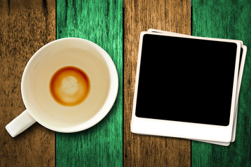 Old film and a cup of coffee on the wooden floor.