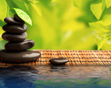 green eco background with spa stones and leaves with water