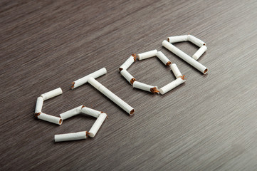 concept of dangers of smoking. word "stop" of cigarettes