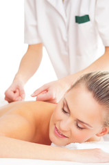 Obraz na płótnie Canvas A young woman laying on a spa massage procedure