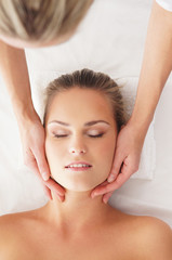 Fototapeta na wymiar Portrit of a young woman laying on a spa massage procedure