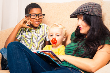 Woman and children reading book