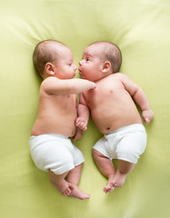 funny twins brothers babies lying on green © Oksana Kuzmina