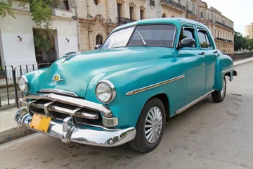 Printed roller blinds Cuban vintage cars Classic blue Plymouth in Havana. Cuba.