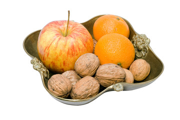 Fruit and nuts in a copper vase