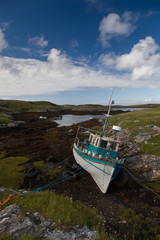 Old fishing boat on the rocks
