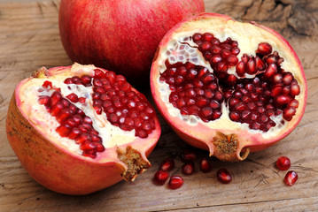 Pomegranate fruits on rustic wood background