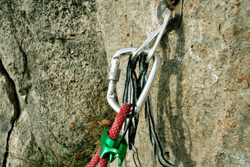 climbing iron with carabiner and rope on rock © Vitalii Nesterchuk