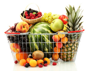 Assortment of exotic fruits in metal basket isolated on white