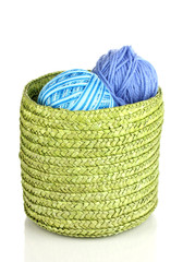 Colorful yarn for knitting in green basket isolated on white
