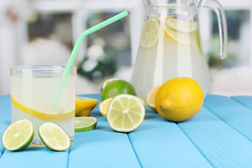 Citrus lemonade in pitcher and glass of citrus around