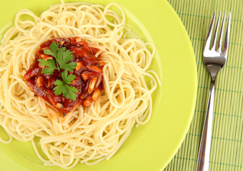 Italian spaghetti in plate on bamboo mat