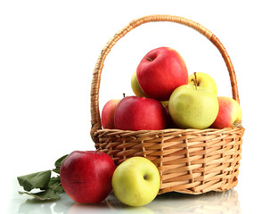juicy apples with green leaves in basket, isolated on white