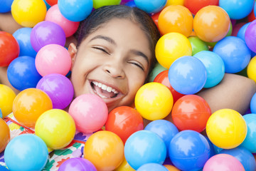 Fototapeta na wymiar African American Girl Child Colorful Plastic Balls