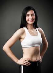 Fototapeta premium Beautiful sporty woman standing with hands on hips