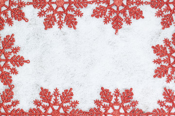 Christmas decorative frame with snowflakes closeup on snow.