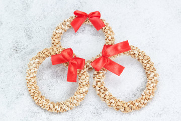 Christmas decorative wreath of straw closeup in the snow.