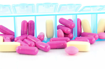 Closed up capsule and tablets in daily pill box
