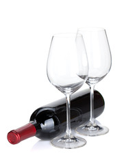 Red wine bottle and empty glasses