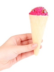Scoop of the strawberry ice cream in the waffle cone decorated