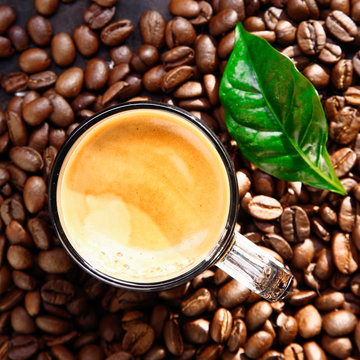 Top view of coffee cup on bean bacground