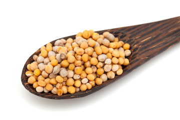 mustard in a wooden spoon