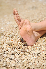 Relaxation on beach, detail of male feet
