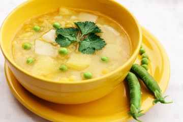 Meatless soup in round yellow cup.