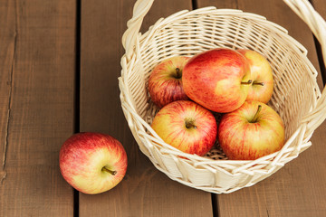Beautiful and ripe apples in wattled basket