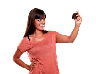 Smiling woman taking a picture with her mobile