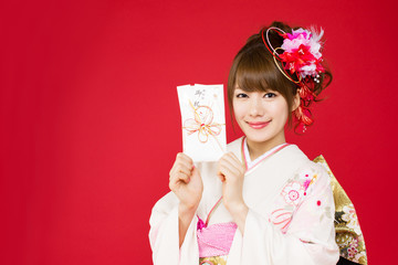 Beautiful japanese kimono woman on red background
