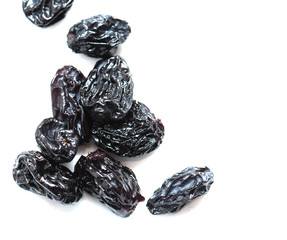 black raisins on a white background