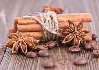 Obraz na płótnie Canvas cinnamon sticks tied with twine, coffee and star anise