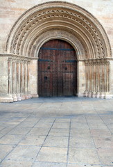 Wooden gate to the Catholic temple with an arch