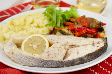 boiled perch with mashed potato and vegetables on the plate