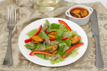 salad with mussels on the white plate