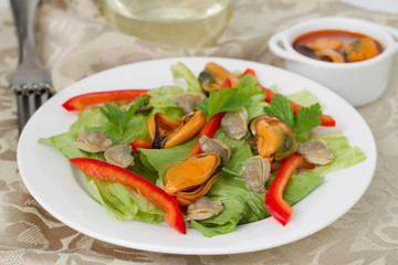 salad with mussels on the white plate