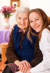 Young doctor holds the elderly woman hands